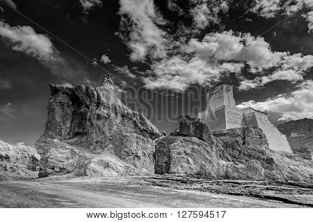 Ruins and Basgo Monastery surrounded with stones and rocks sky with clouds in the background Himalayan Mountain range Leh Ladakh Jammu and Kashmir India - black and white stock image of Indian monasteries