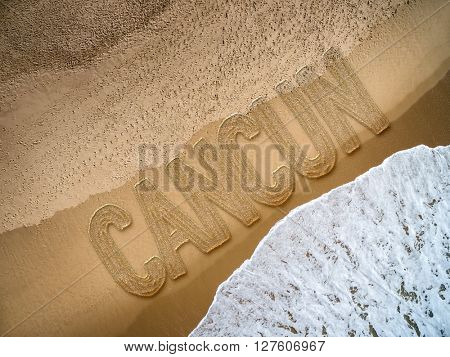 Cancun written on the beach