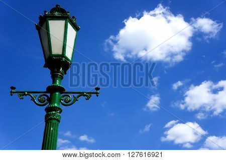 green street lamp post on blue sky background