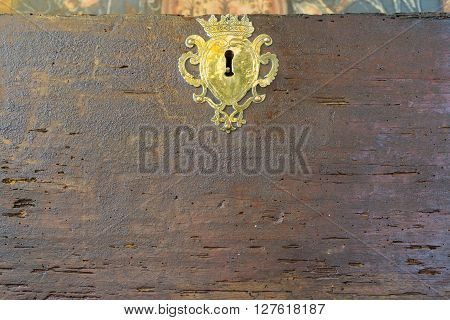 Front view of old vintage lock on woodworm wooden