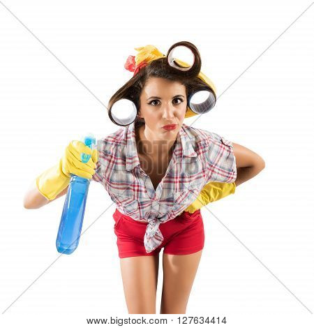Simpering girl housewife with gloves and spray