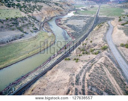 aerial view railroad, highway and  of the Colorado RIver above Dotsero, Colorado, springtime scenery