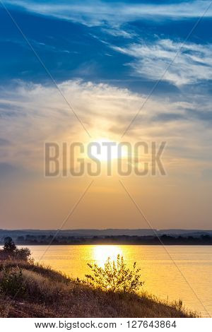 Summer sunset on the riverbank. City bridges over the river Dniepr. Kaniv. Ukraine.