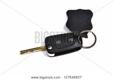Black car key isolated on a completely white background.