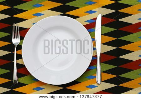 Diet concept - Empty plate with blank paper on the colorful background