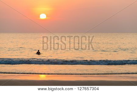 Beautiful seascape silhouette lonely man at sunset.