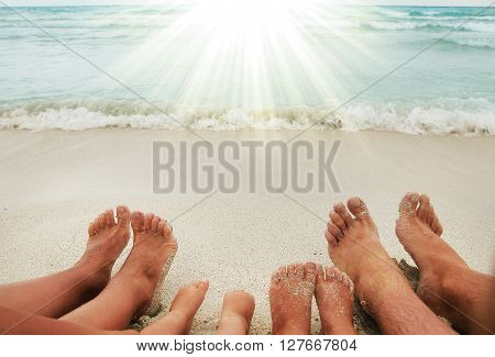 a Family feet on the sand on the beach