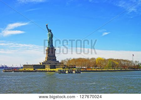 Statue on Liberty Island. New York City USA. In Upper New York Bay. Tourists are walking on the island.