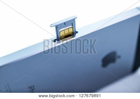 PARIS FRANCE - APR 21 2016: Instalation of the new SIM card in the new Apple iPhone SE combining the updated processor 4K rear camera touch id retina display