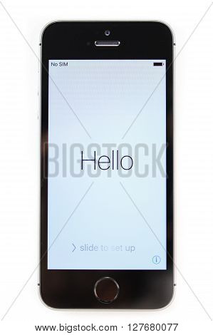 PARIS FRANCE - APR 21 2016: First start of the new iPhone SE with Hello message on screen - the new phone combines the updated processor 4K rear camera touch id retina display