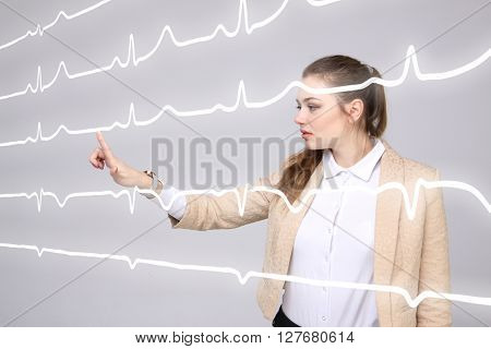 Doctor woman working with cardiogram lines