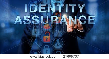 Administrator pressing IDENTITY ASSURANCE on an interactive touch screen display. Information technology metaphor and online concept for the ability to verify the validity of electronic credentials.
