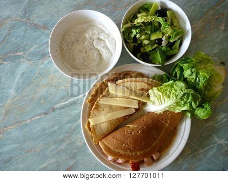 Filled Pancakes Served With Green Salad And Sauce