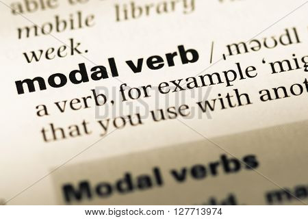 Close Up Of Old English Dictionary Page With Word Modal Verb.
