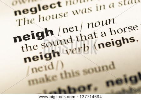 Close Up Of Old English Dictionary Page With Word Neigh.