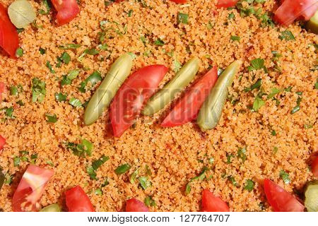 Kisir, traditional turkish salad, Bulgur wheat prepared with tomato paste, fresh tomatoes, parsley, olive oil.selective focus