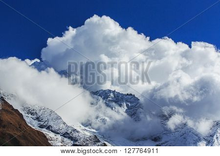 Dramatic sea of clouds and snow covered peaks in Himalaya