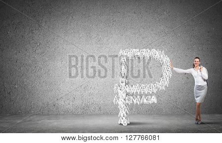 Young confident businesswoman leaning on big rouble sign