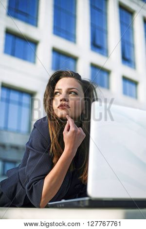 Beautyful woman student working outside with laptop