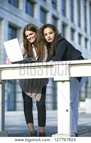 Young womens working together outside and having fun