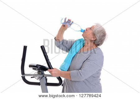 Female Senior Train With Fitness Machine And Drinking Water