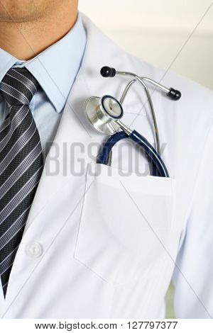 Male medicine therapeutist doctor chest with stethoscope in pocket closeup. Medical tools and instruments shop, physical and disease prevention, patient examination, 911, healthy lifestyle concept