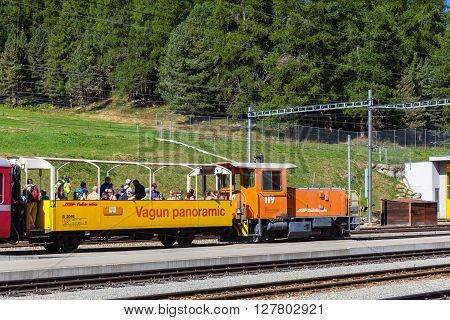 Celerina Switzerland - August 29 2015 - Tourists taking the panoramic sightseeing train of Rhaetian Railway in Grisons travel on the Glacier Express line Switzerland.