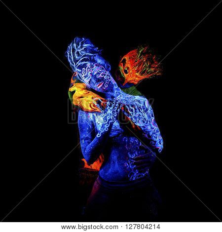 Fire and Air. Body art glowing in ultraviolet light, four elements, isolated on black background