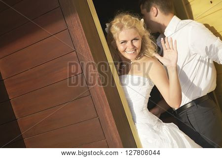 Lovely Bride Saying Good Bye Near Door After Wedding.
