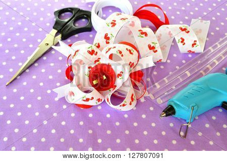 Bright bow of ribbon, children hair accessory, ribbon set, scissors, hot glue gun