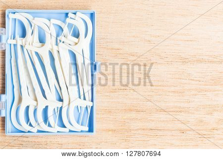 Oral Device : White Dental Flossers On Wooden Background