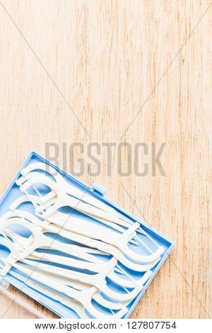Oral Device : White Dental Flossers On Wooden Background