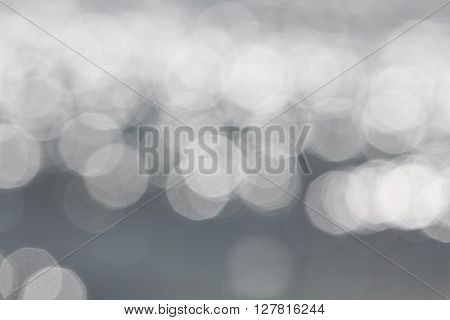 Light silver abstract bogey lights background. Glowing magic bokeh