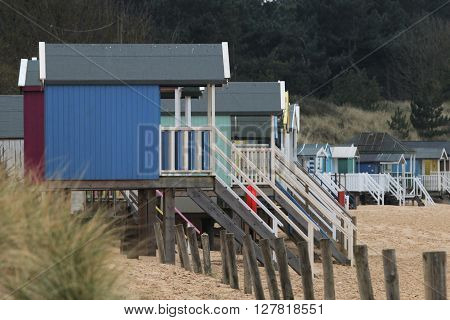 beach huts along the coastline of norfolk