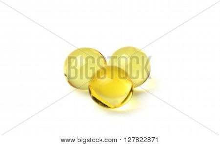 Fish oil capsules closeup isolated on white background.