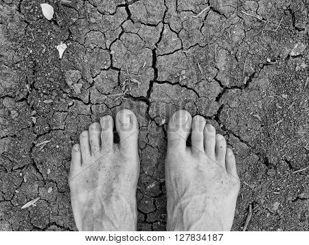 Two Tired Male Legs On Dry Cracked Clay. Dry Cracked Clay
