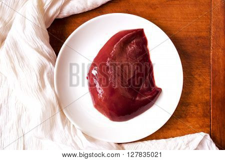 High iron beef liver on a wooden table