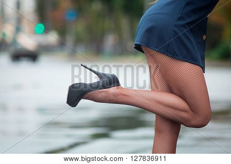 Young beautiful police woman stops car for checking driver license