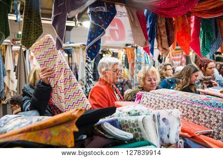 Womens Buying Fabrics At Market