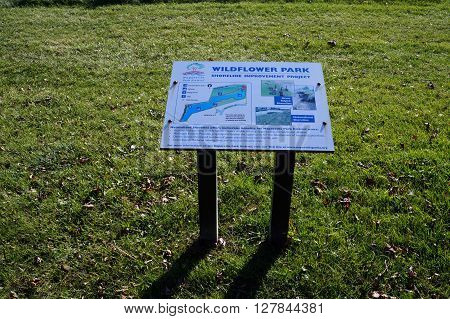 NAPERVILLE, ILLINOIS / UNITED STATES - NOVEMBER 3, 2015: A sign provides information on the Shoreline Improvement Project in Naperville's Wildflower Park.