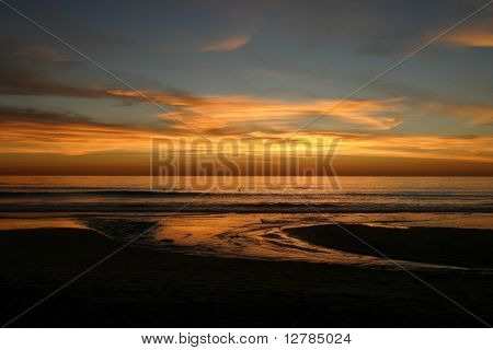 A Stream Meets the Ocean at Sunset