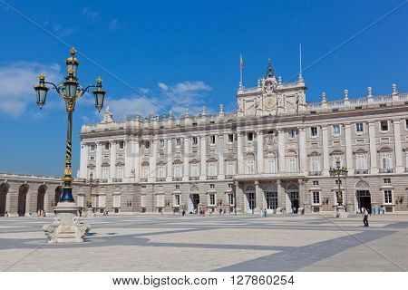 MADRID SPAIN - SEPTEMBER 24 2013: Tourists near Royal palace. Royal palace in Madrid (Palacio Real de Madrid) differently East palace (Palacio de Oriente) - official residence of kings of Spain.