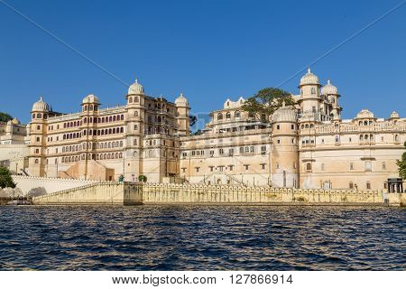 UDAIPUR INDIA - 20TH MARCH 2016: Part of the city palace in Udaipur during the day from the lake.
