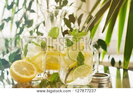 Homemade lemonade in mason jar over summer background, selective focus