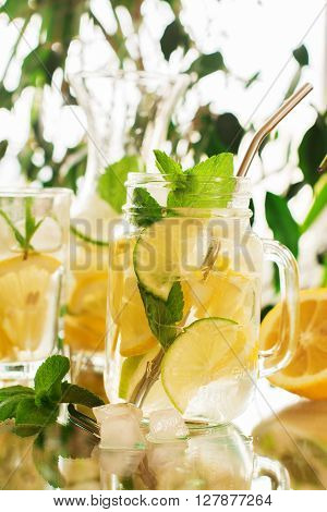 Homemade lemonade in mason jar over summer background, selective focus
