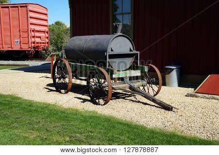PLAINFIELD, ILLINOIS / UNITED STATES - SEPTEMBER 20, 2015: An antique oil cart is on display outside the old Plainfield, Illinois Depot, which is now a museum operated by the Plainfield Historic Preservation Commission.