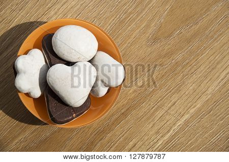 Cookies in an orange plate on a wooden table