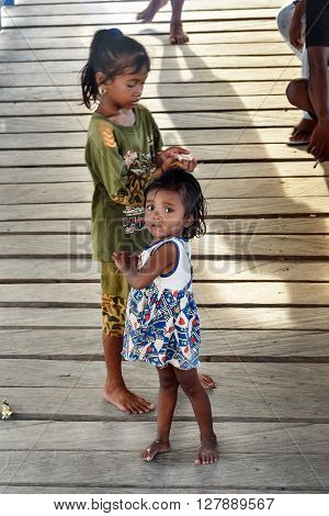 Indonesian Children On The Pier In Tobil Village Togean Islands
