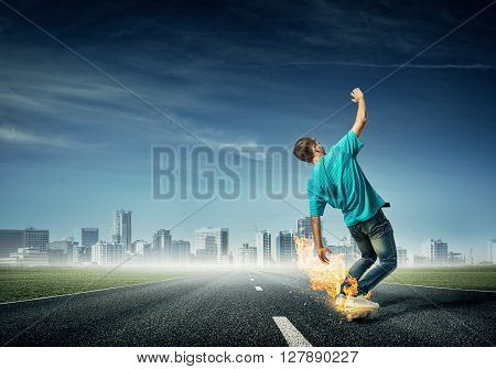 Skater boy riding on his skateboard burning in fire