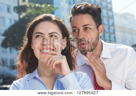 Talking business team in the city with modern office buildings in the background